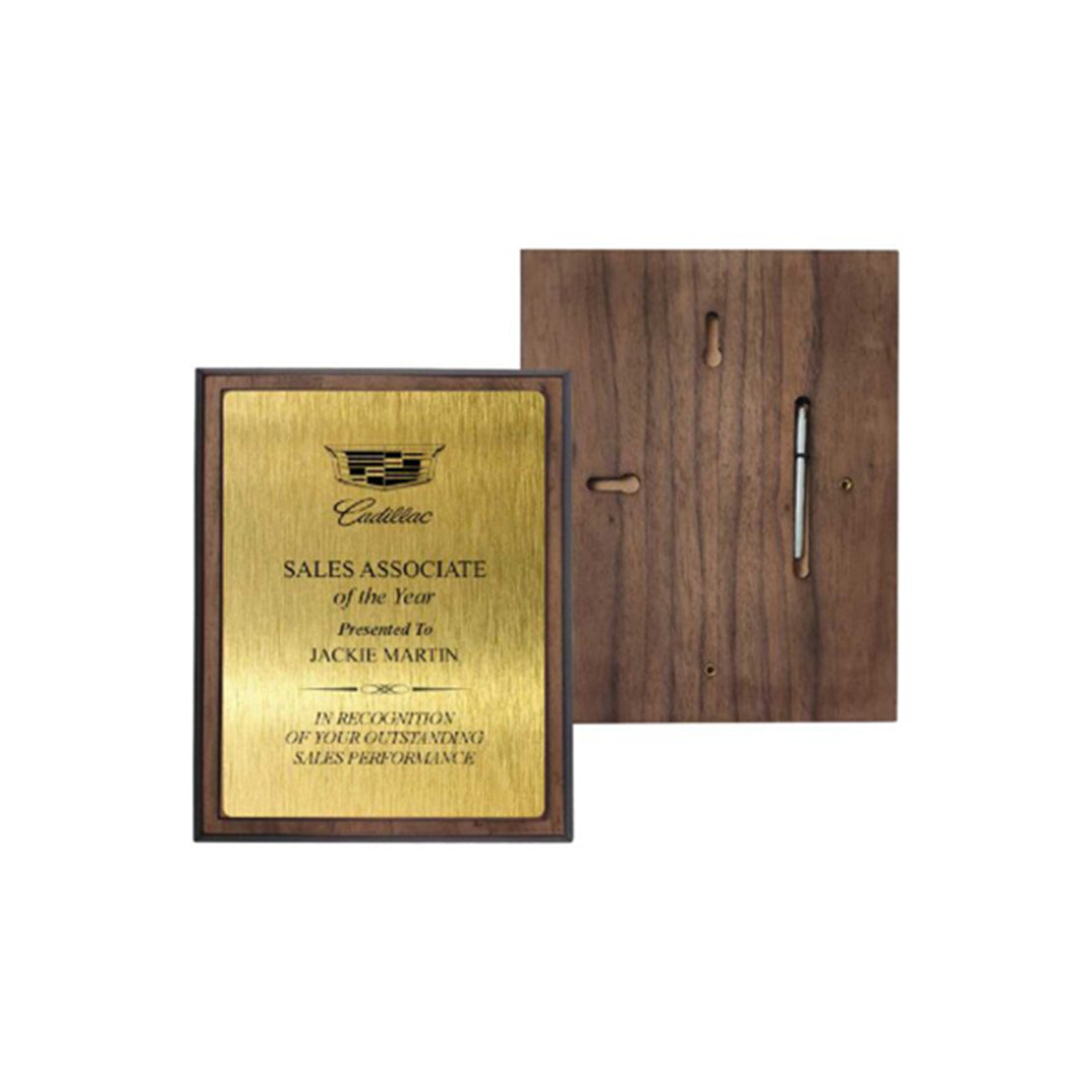 Gold plaque with text and Cadillac logo on a wooden frame, displayed against a white background.